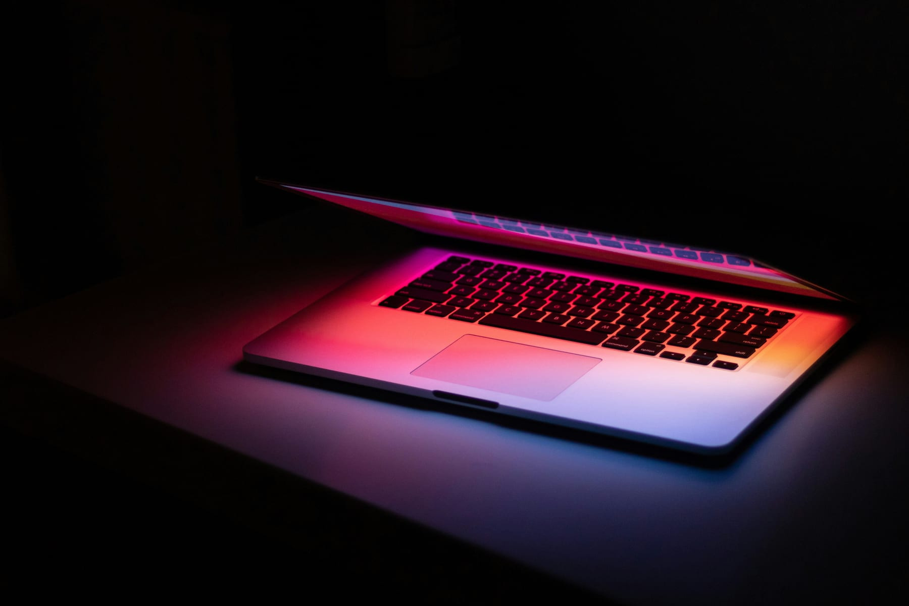 A laptop glowing with warm light