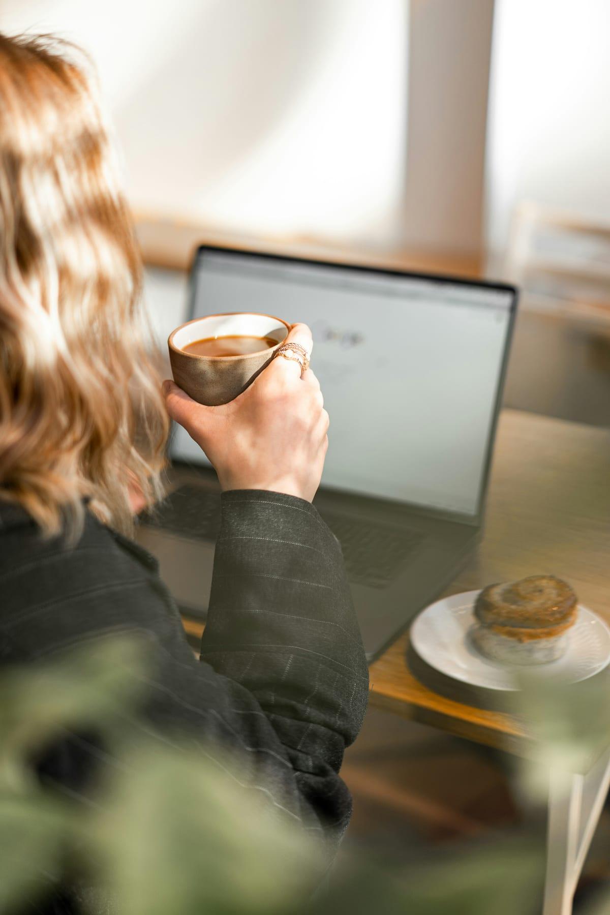 Working at a laptop with a coffee